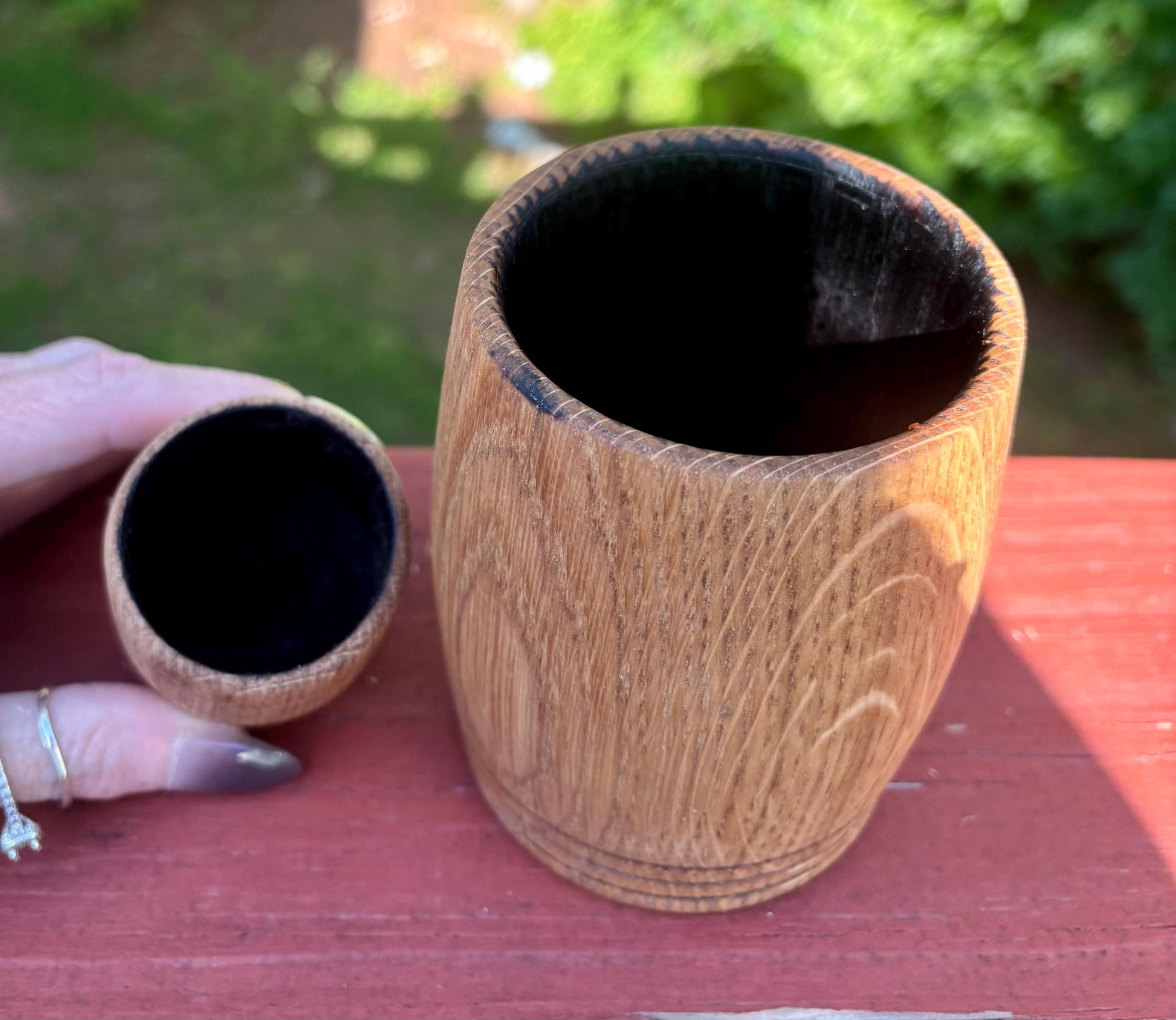 The charred inside of our White Oak Hand Charred Shot Glass (on the left) and our full size Whiskey Cup (on the right).